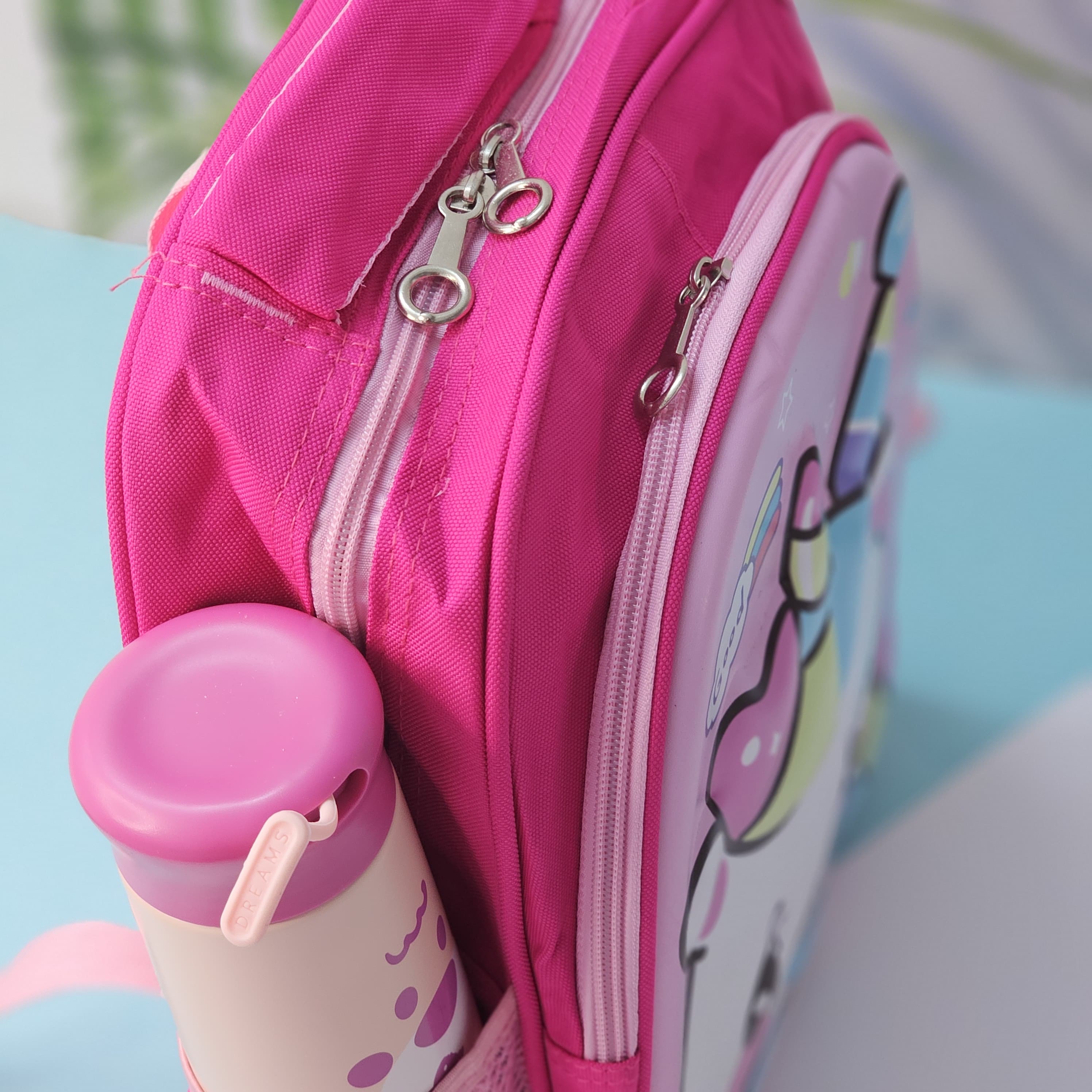 Usmile Toys girls' school backpack: a vibrant pink bag with a large, smiling unicorn graphic and a 'Good' speech bubble, perfect for young students." www.usmile.toys